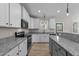 Spacious kitchen featuring granite countertops, white cabinets, stainless appliances, and an island at 412 W Stalllings St, Clayton, NC 27520