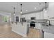 Modern kitchen with granite countertops, stainless steel appliances, and recessed lighting at 412 W Stalllings St, Clayton, NC 27520