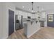 Kitchen showcasing white cabinets, granite counters, island, and stainless steel refrigerator at 412 W Stalllings St, Clayton, NC 27520