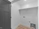 Clean laundry room with a utility sink and shelf at 412 W Stalllings St, Clayton, NC 27520