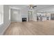 Open-concept living room features a fireplace, ceiling fan, and light wood-look flooring at 412 W Stalllings St, Clayton, NC 27520