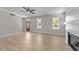 Living room features wood-look floors, several windows, and a staircase to the second floor at 412 W Stalllings St, Clayton, NC 27520