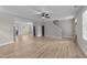 Open-concept living room features wood-look flooring, lots of windows, and access to other rooms at 412 W Stalllings St, Clayton, NC 27520