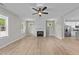 Bright living room with light-colored walls, wood-look flooring, and a ceiling fan at 412 W Stalllings St, Clayton, NC 27520