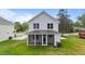 The home's back with a screened-in porch that overlooks a spacious lawn at 412 W Stalllings St, Clayton, NC 27520