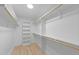 Walk-in closet with wooden bars, built-in shelving, and ample storage space at 412 W Stalllings St, Clayton, NC 27520
