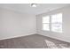 Bedroom showcasing carpeted floors and a window with exterior view at 416 Longleaf Glen Ln, Zebulon, NC 27597