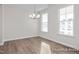 Bright dining room features hardwood floors, large windows providing ample light, and a contemporary chandelier at 416 Longleaf Glen Ln, Zebulon, NC 27597