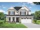 Charming two-story home with stone accents, manicured lawn, and attached two car garage at 416 Longleaf Glen Ln, Zebulon, NC 27597