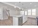 Open-concept kitchen with a marble-topped island, stainless steel appliances, and hardwood flooring, perfect for entertaining at 416 Longleaf Glen Ln, Zebulon, NC 27597