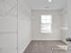 Walk-in closet with carpet, a window allowing natural light, and built in shelving at 416 Longleaf Glen Ln, Zebulon, NC 27597