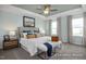 Luxurious bedroom with a tray ceiling, soft blue walls, a comfortable bed, and elegant decor at 420 Longleaf Glen Ln, Zebulon, NC 27597