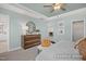 Stylish bedroom with unique ceiling fan, wood dresser, and inviting decor at 420 Longleaf Glen Ln, Zebulon, NC 27597