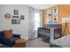 Cozy Bedroom featuring blue crib, chair, and colorful wall art at 420 Longleaf Glen Ln, Zebulon, NC 27597