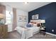 Cozy bedroom showcases a navy accent wall, stylish bedding, complementary decor, and a bright window at 420 Longleaf Glen Ln, Zebulon, NC 27597