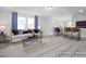Functional bonus room with a comfortable sofa, desk area, and bar seating, perfect for both work and leisure at 420 Longleaf Glen Ln, Zebulon, NC 27597