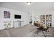 Versatile bonus room with a TV, storage unit, and comfortable seating, perfect for entertainment and relaxation at 420 Longleaf Glen Ln, Zebulon, NC 27597