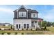 Charming two-story home with a mix of gray and white siding, a cozy front porch, and a well-manicured lawn at 420 Longleaf Glen Ln, Zebulon, NC 27597