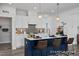 Well-lit kitchen featuring a kitchen island, white cabinets, modern appliances, and a pantry for ample storage at 420 Longleaf Glen Ln, Zebulon, NC 27597
