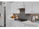 Contemporary kitchen with white countertops and cabinets, modern appliances, and stylish backsplash at 420 Longleaf Glen Ln, Zebulon, NC 27597