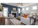 Comfortable living room with a fireplace, stylish furniture, and a large rug, with ample natural light at 420 Longleaf Glen Ln, Zebulon, NC 27597