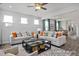 Spacious living room with dual sofas, a glass-top coffee table, and bright, neutral walls and furniture at 420 Longleaf Glen Ln, Zebulon, NC 27597