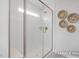 Walk-in shower with white tiled walls, glass door, and built-in bench at 420 Longleaf Glen Ln, Zebulon, NC 27597