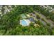 Aerial shot of community amenities like pool, tennis court, volleyball court, and playground nested in lush greenery at 513 Heswall Ct, Rolesville, NC 27571