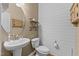 Cozy half bath featuring shiplap walls, a round mirror, and wood-look floors at 513 Heswall Ct, Rolesville, NC 27571