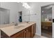 Bathroom featuring a double vanity with light countertops and wood cabinets at 513 Heswall Ct, Rolesville, NC 27571