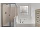 Bright bathroom featuring soaking tub and glass-enclosed shower at 513 Heswall Ct, Rolesville, NC 27571