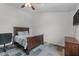 Bedroom featuring a bed with wooden frame, carpet, and modern color palette at 513 Heswall Ct, Rolesville, NC 27571