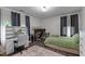 Well-lit bedroom with a desk, neutral walls, and carpet flooring at 513 Heswall Ct, Rolesville, NC 27571