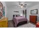 Bedroom with stylish hardwood floors, ceiling fan, and warm accent colors at 513 Heswall Ct, Rolesville, NC 27571