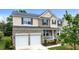 Charming two-story home features a two-car garage and a cozy front porch, complemented by manicured landscaping at 513 Heswall Ct, Rolesville, NC 27571