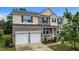 Charming two-story home with a two-car garage, manicured lawn, and inviting front porch at 513 Heswall Ct, Rolesville, NC 27571