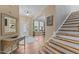 Spacious foyer with hardwood floors, staircase, and decorative accents at 513 Heswall Ct, Rolesville, NC 27571