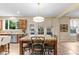 A spacious kitchen with a marble countertop island, stainless appliances and natural light at 513 Heswall Ct, Rolesville, NC 27571