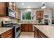Gourmet kitchen featuring granite counters, stainless appliances and wood cabinets at 513 Heswall Ct, Rolesville, NC 27571