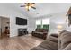 Comfortable living room with fireplace, flat screen TV, and ceiling fan at 513 Heswall Ct, Rolesville, NC 27571