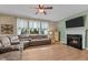 Bright living room featuring a fireplace, a comfortable sectional sofa, and a large window at 513 Heswall Ct, Rolesville, NC 27571