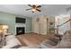 Spacious living room with a fireplace, plush sofa, and lots of natural light at 513 Heswall Ct, Rolesville, NC 27571