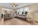 Bright living room features an L-shaped sofa, wood floors and a ceiling fan at 513 Heswall Ct, Rolesville, NC 27571