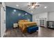 An inviting main bedroom features a blue accent wall and a ceiling fan at 513 Heswall Ct, Rolesville, NC 27571