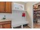 A mudroom offers coat hooks and shelving for storage and organization at 513 Heswall Ct, Rolesville, NC 27571