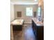 Well-lit bathroom with double sinks, a soaking tub, and modern fixtures, creating a spa-like retreat at 550 Saplin Branch Rd, Timberlake, NC 27583