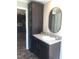 Bathroom vanity offers a sink, storage and granite countertop with an oval mirror at 550 Saplin Branch Rd, Timberlake, NC 27583
