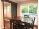 Inviting dining area with a wooden table, chairs and a sliding barn door leading to the mudroom and a sliding glass door to the deck at 550 Saplin Branch Rd, Timberlake, NC 27583