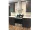 Modern kitchen featuring a stainless steel range hood, granite countertops, and ample cabinet space at 550 Saplin Branch Rd, Timberlake, NC 27583
