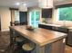 Modern kitchen with spacious island, stainless steel sink, and adjacent dining area at 550 Saplin Branch Rd, Timberlake, NC 27583